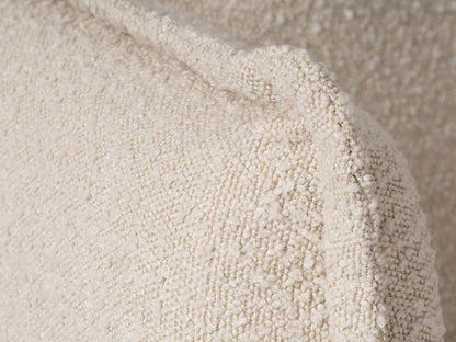 Modern boucle loveseat in cream, featuring soft textured fabric, sleek wooden legs, and plush cushioning for comfort and style, perfect for contemporary living rooms or cozy reading nooks.