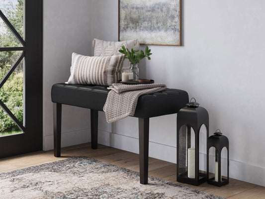 Black leather bench with sleek, modern design featuring a sturdy metal frame, tufted seat cushion, and minimalist style, perfect for contemporary living spaces or entryways.