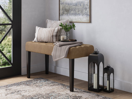 Beige entryway bench with cushioned seat, wooden legs, and slatted lower shelf for storage. Ideal for hallways, foyers, or mudrooms.