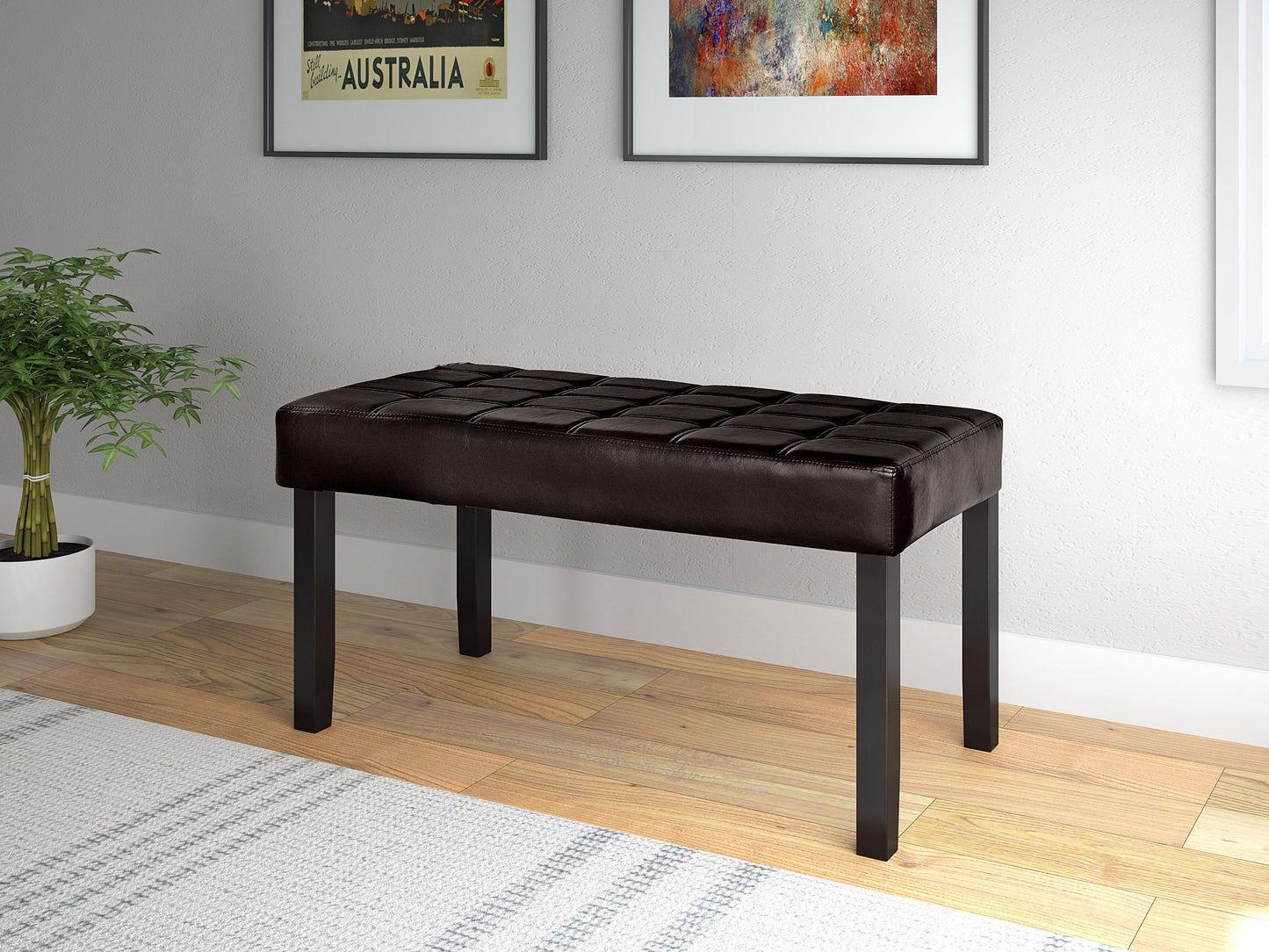 Brown leather bench with tufted seat, wooden legs, sleek modern design, and brass nailhead trim. Perfect for living rooms, entryways, or bedrooms. Durable, stylish, and comfortable seating solution.