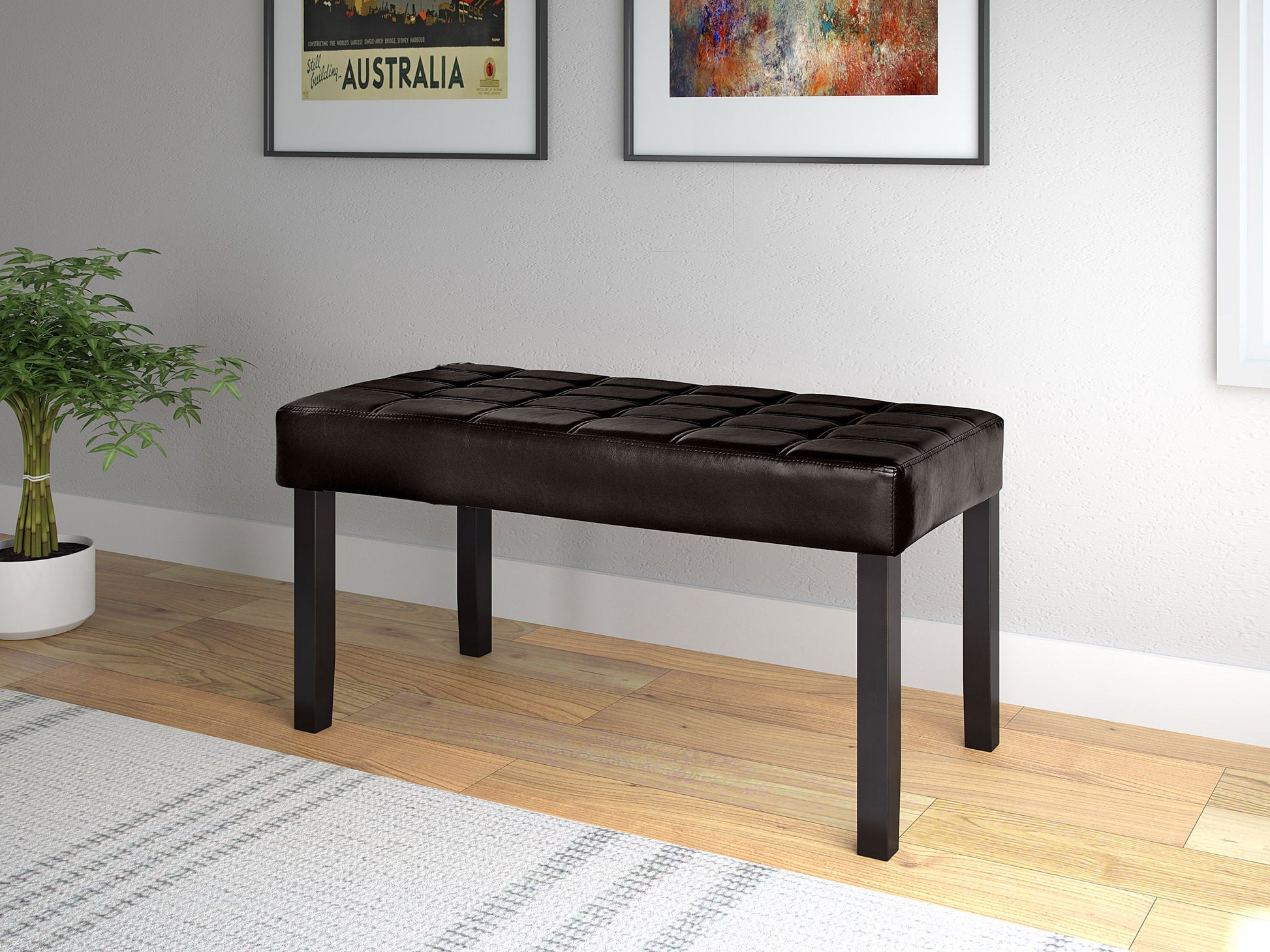 Brown leather bench with tufted seat, wooden legs, sleek modern design, and brass nailhead trim. Perfect for living rooms, entryways, or bedrooms. Durable, stylish, and comfortable seating solution.