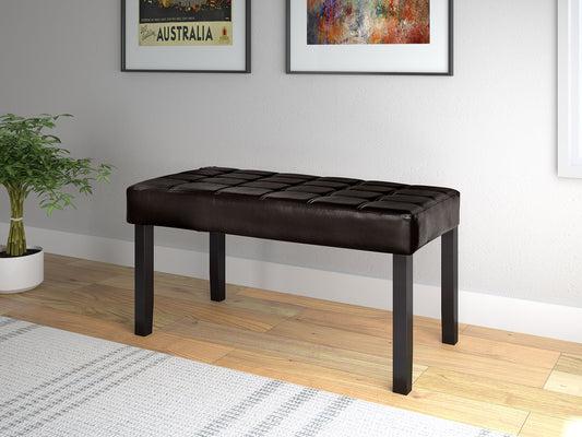 Brown leather bench with tufted seat, wooden legs, sleek modern design, and brass nailhead trim. Perfect for living rooms, entryways, or bedrooms. Durable, stylish, and comfortable seating solution.