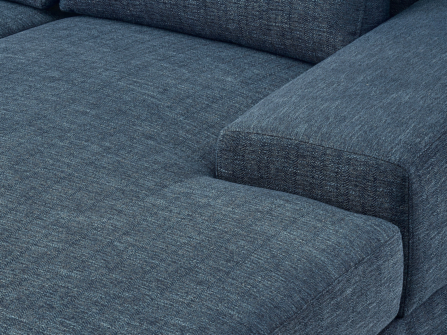 Modern blue sectional sofa, right-facing with plush cushions, sleek lines, and a durable fabric finish, perfect for contemporary living rooms. Features include adjustable headrests and stainless steel legs for added style and support.