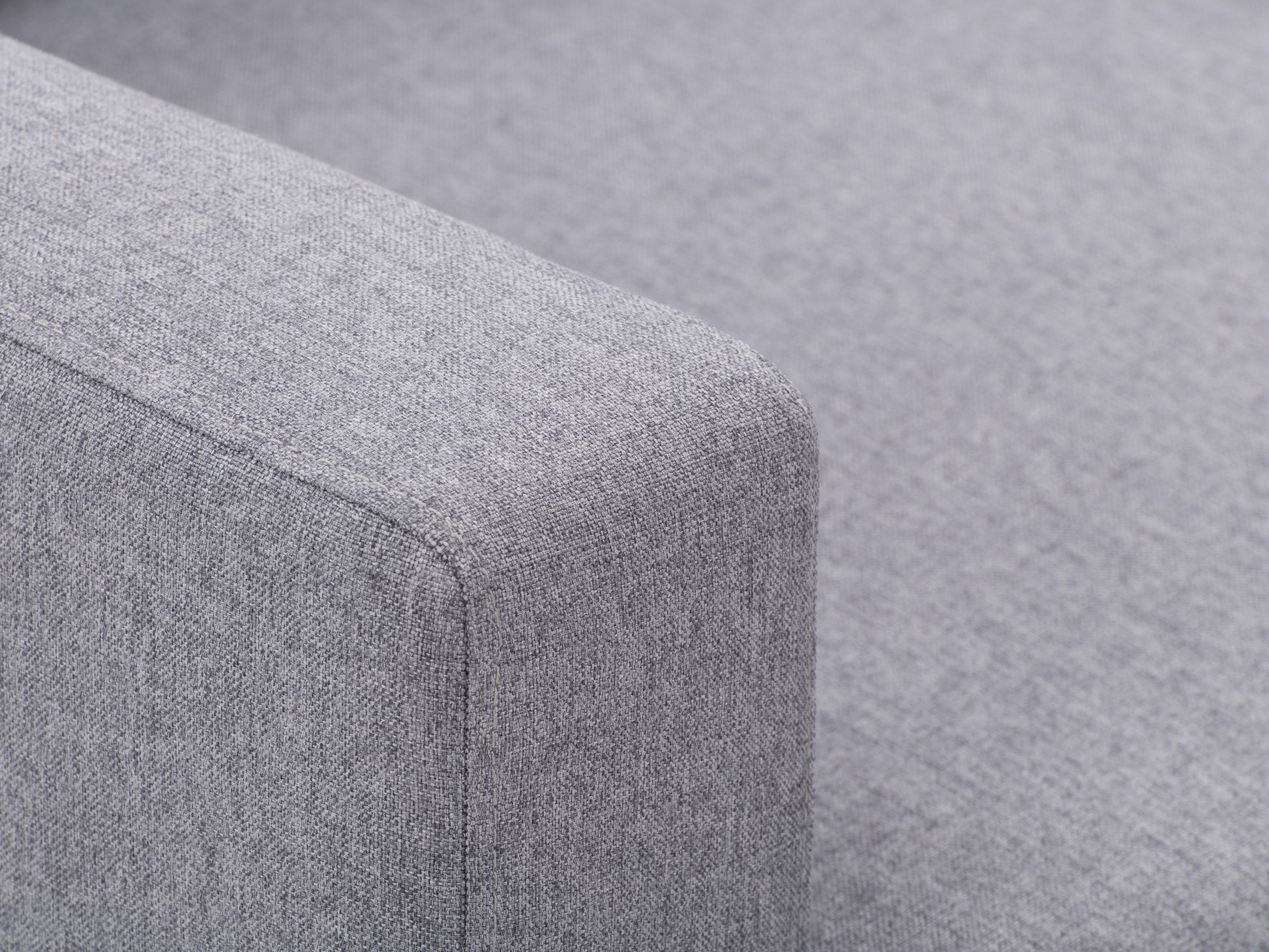 Grey tufted accent chair with wooden legs, featuring soft fabric upholstery, button-tufted backrest, and cushioned seat for comfort. Ideal for living rooms or reading nooks.