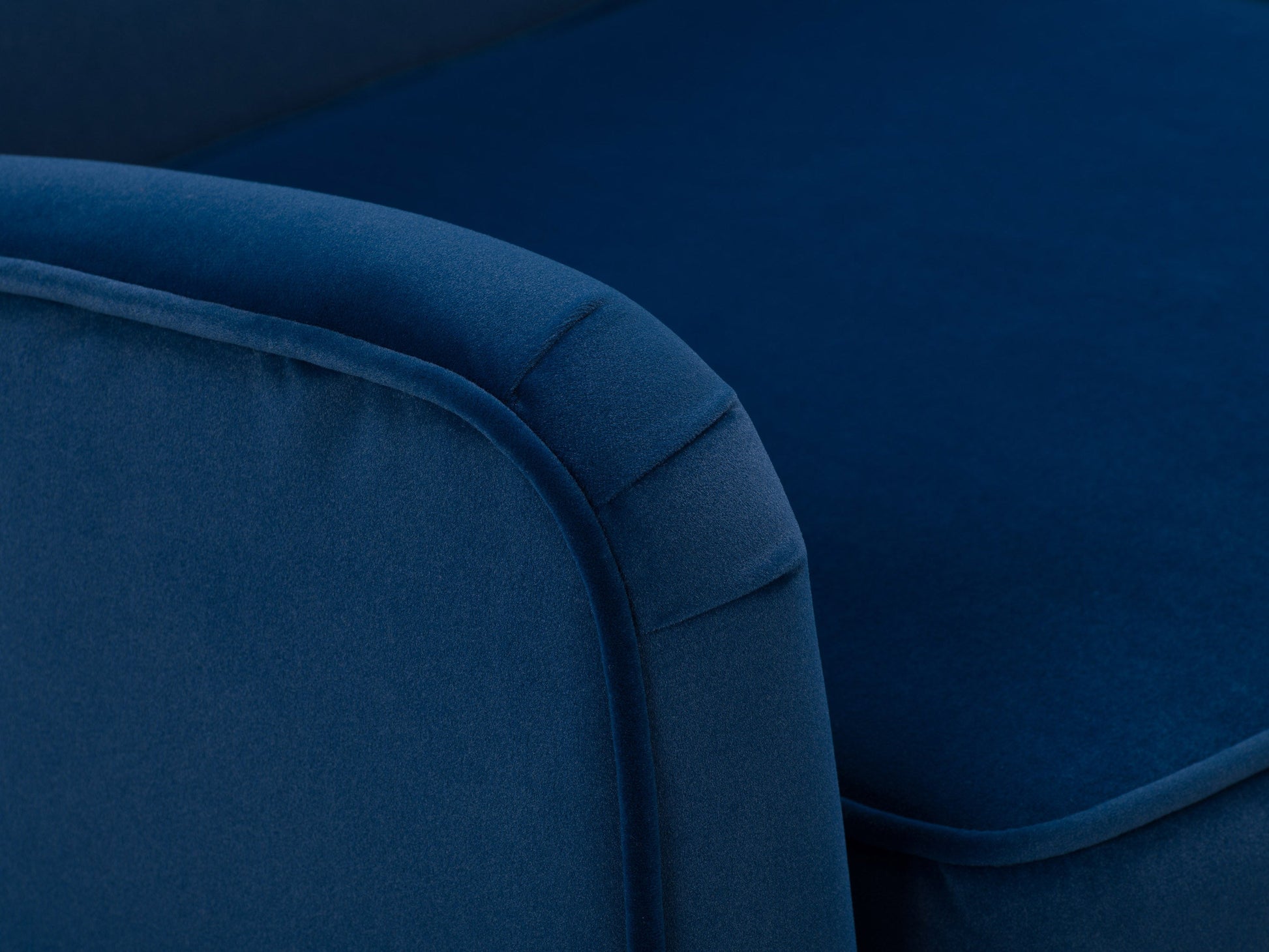 Luxurious blue velvet accent chair with tufted backrest, sleek gold legs, and plush cushioning, perfect for modern living rooms or stylish office spaces.