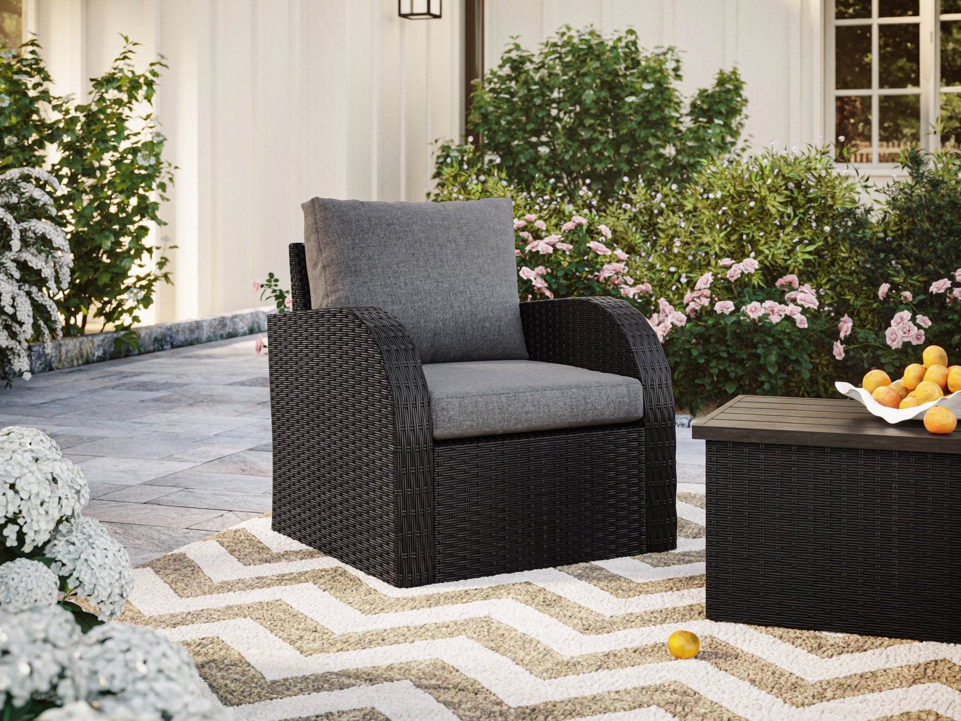 Grey outdoor wicker patio chair with curved armrests, sturdy aluminum frame, and comfortable cushion. Ideal for garden or balcony seating, featuring weather-resistant wicker and sleek, modern design.