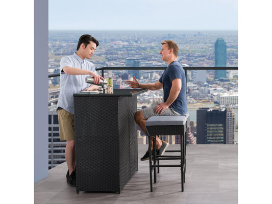 Three-piece patio bar set featuring a high table and two bar stools with beige cushions, crafted from durable, weather-resistant dark brown wicker, perfect for outdoor entertaining and relaxation.