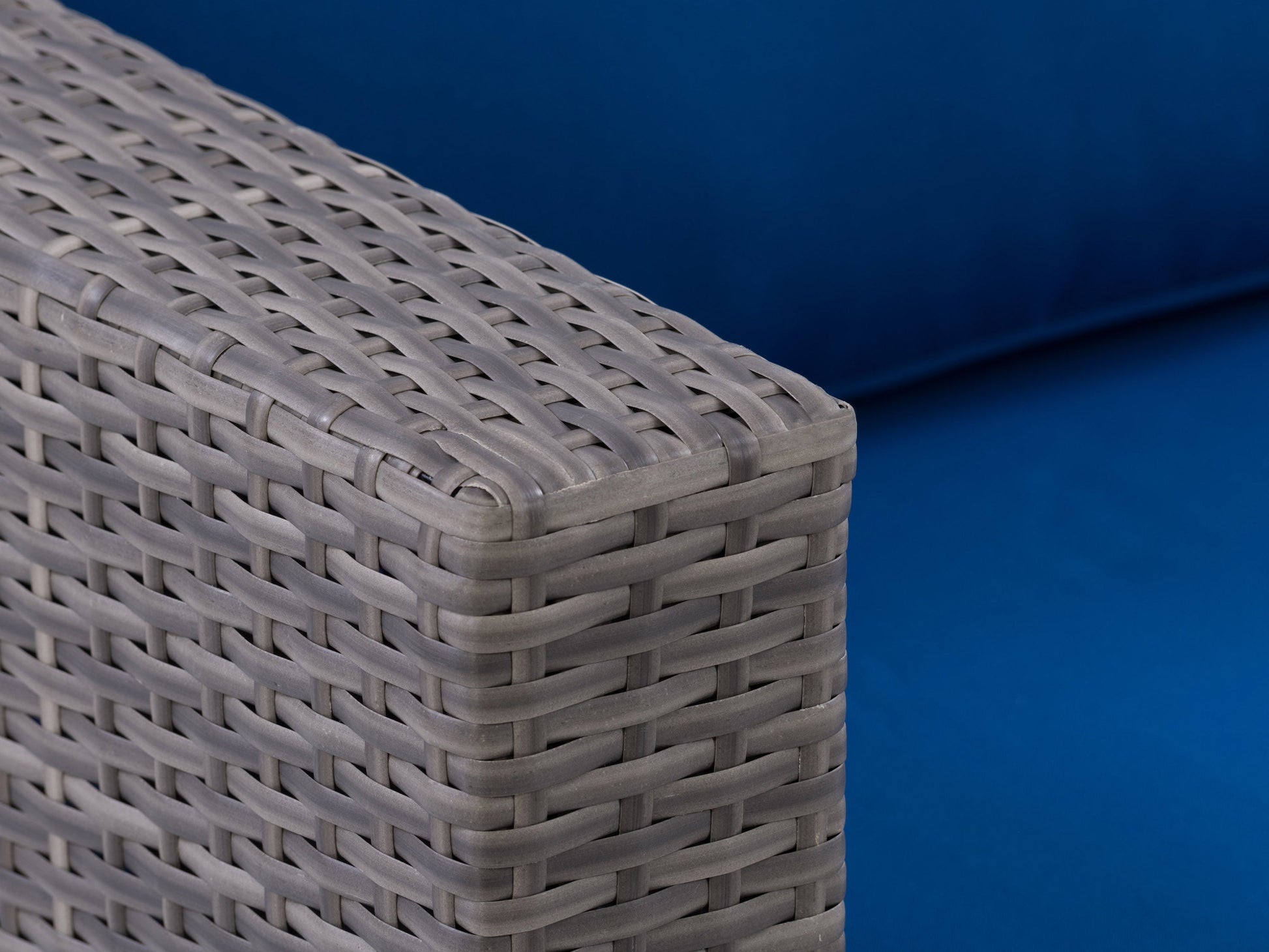 Wicker patio armchair with beige cushions, featuring a sturdy aluminum frame and intricate woven wicker design, perfect for outdoor seating.