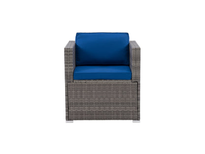 Wicker armchair with beige cushions, natural rattan frame, and curved armrests, ideal for patio or outdoor seating.
