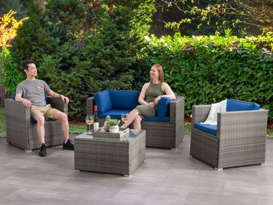Outdoor patio conversation set, 5-piece, featuring a modern gray wicker sofa, matching armchairs with plush beige cushions, glass-top coffee table, and a versatile ottoman, ideal for stylish outdoor lounging.