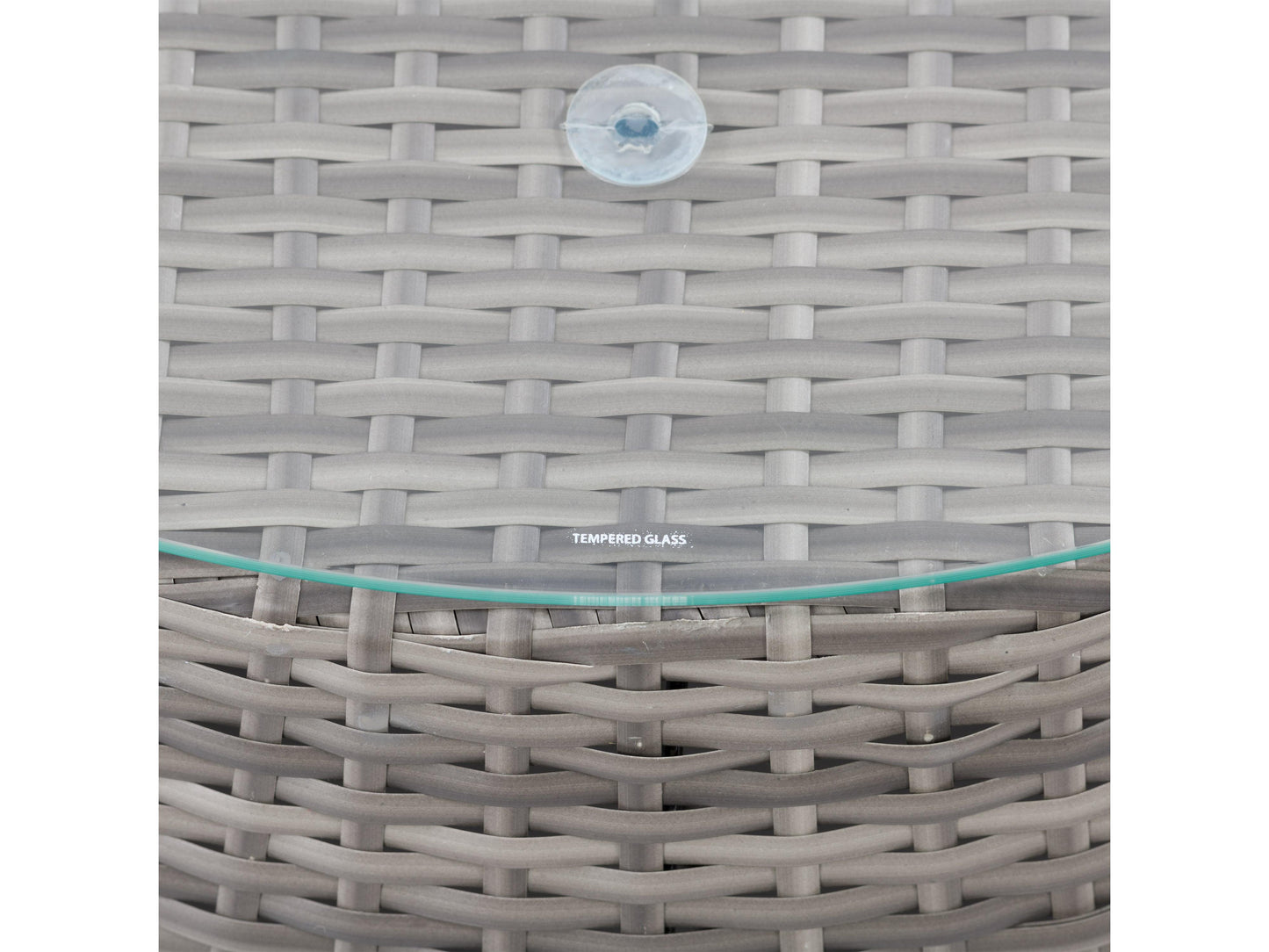 Wicker coffee table with round glass top, natural brown woven wicker base, and sturdy construction, perfect for outdoor patio use.