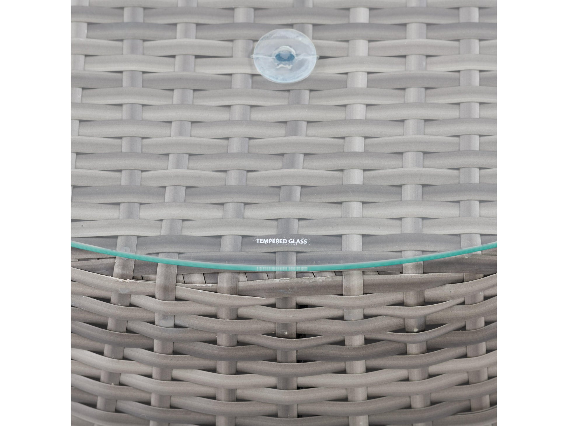 Wicker coffee table with round glass top, natural brown woven wicker base, and sturdy construction, perfect for outdoor patio use.