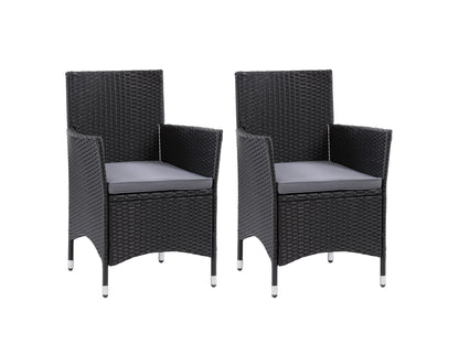 Gray wicker patio dining set with six cushioned chairs, rectangular glass-top table, and weather-resistant materials, perfect for outdoor dining and entertaining.