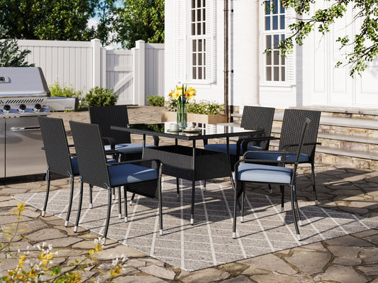Gray wicker patio dining set with six cushioned chairs, rectangular glass-top table, and weather-resistant materials, perfect for outdoor dining and entertaining.