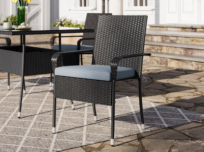 Gray wicker patio dining set with six cushioned chairs, rectangular glass-top table, and weather-resistant materials, perfect for outdoor dining and entertaining.