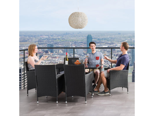 Gray wicker patio dining set with six cushioned chairs, rectangular glass-top table, and weather-resistant materials, perfect for outdoor dining and entertaining.