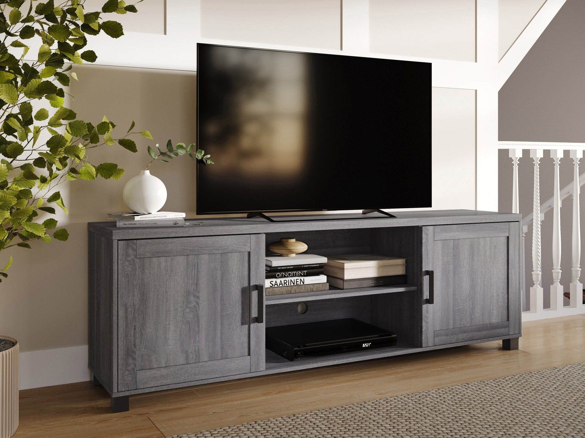 Dark grey TV stand with doors, designed for TVs up to 85 inches. Features sleek, modern design, smooth finish, and ample storage space for media devices and accessories.
