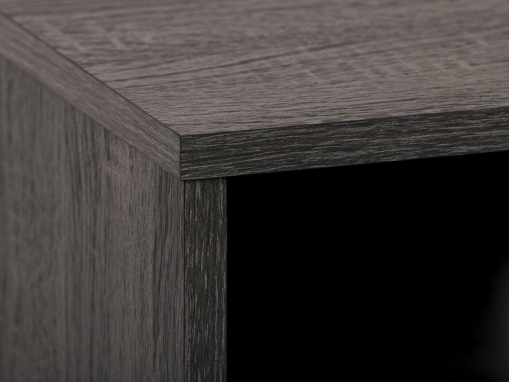 Dark grey TV bench with open shelves, suitable for TVs up to 85 inches. Features sleek, modern design with ample storage space for media devices, books, and decor. Durable wood construction with smooth finish.