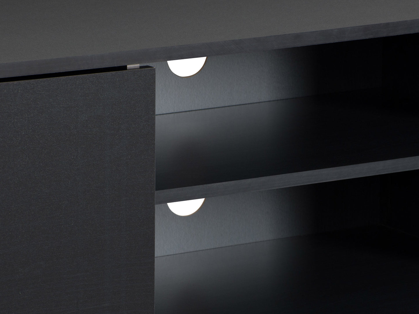 Modern black TV stand for TVs up to 85 inches, featuring sleek lines, minimalist design, and ample storage with open shelves and cabinets. Made of durable materials with a smooth finish.