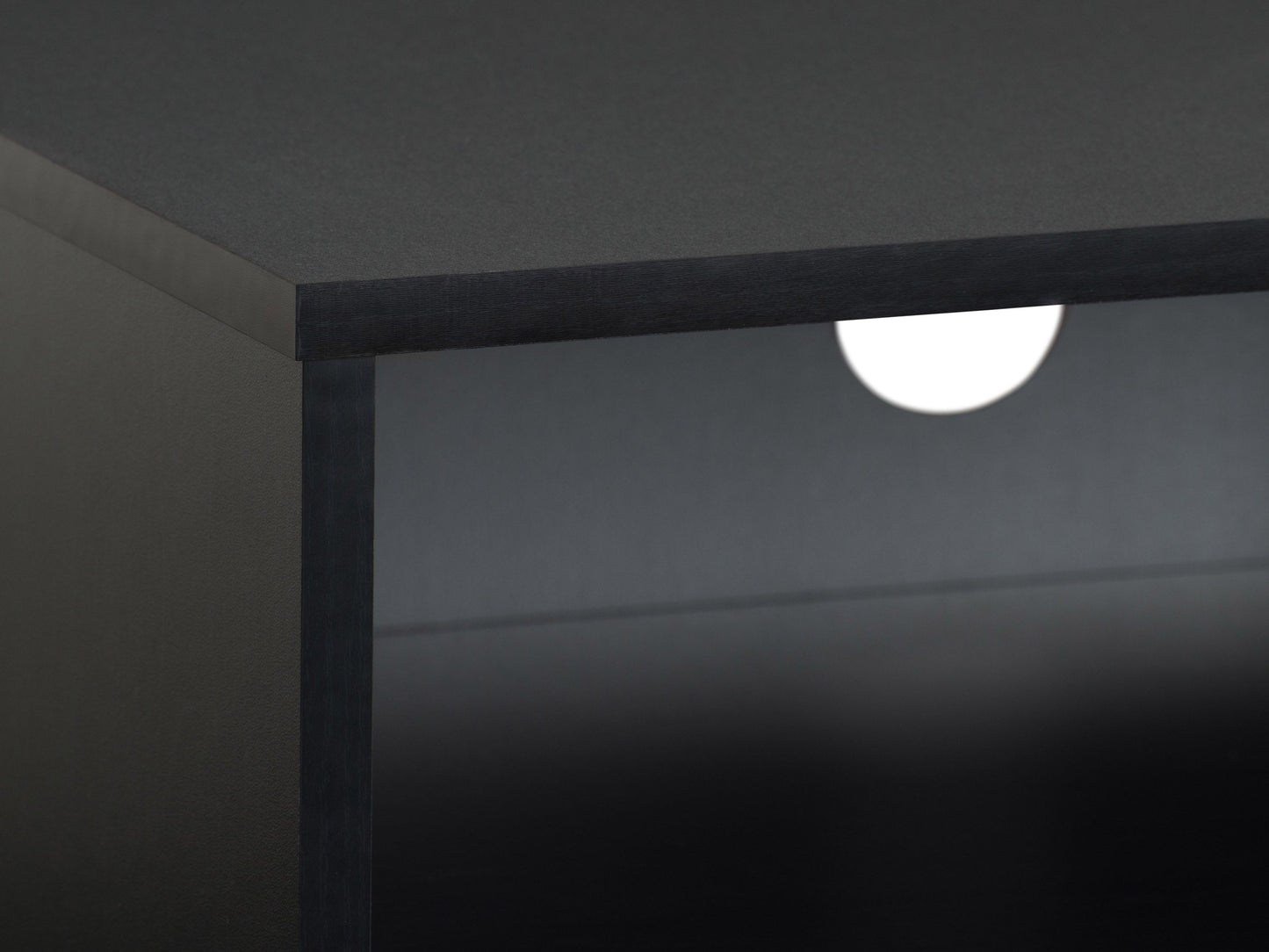 Modern black TV stand for TVs up to 85 inches, featuring sleek lines, minimalist design, and ample storage with open shelves and cabinets. Made of durable materials with a smooth finish.