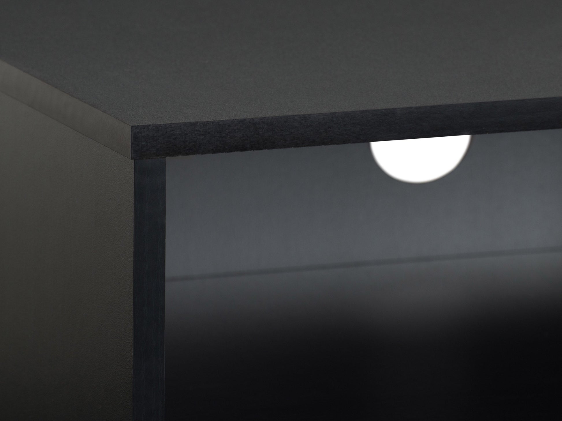 Modern black TV stand for TVs up to 85 inches, featuring sleek lines, minimalist design, and ample storage with open shelves and cabinets. Made of durable materials with a smooth finish.