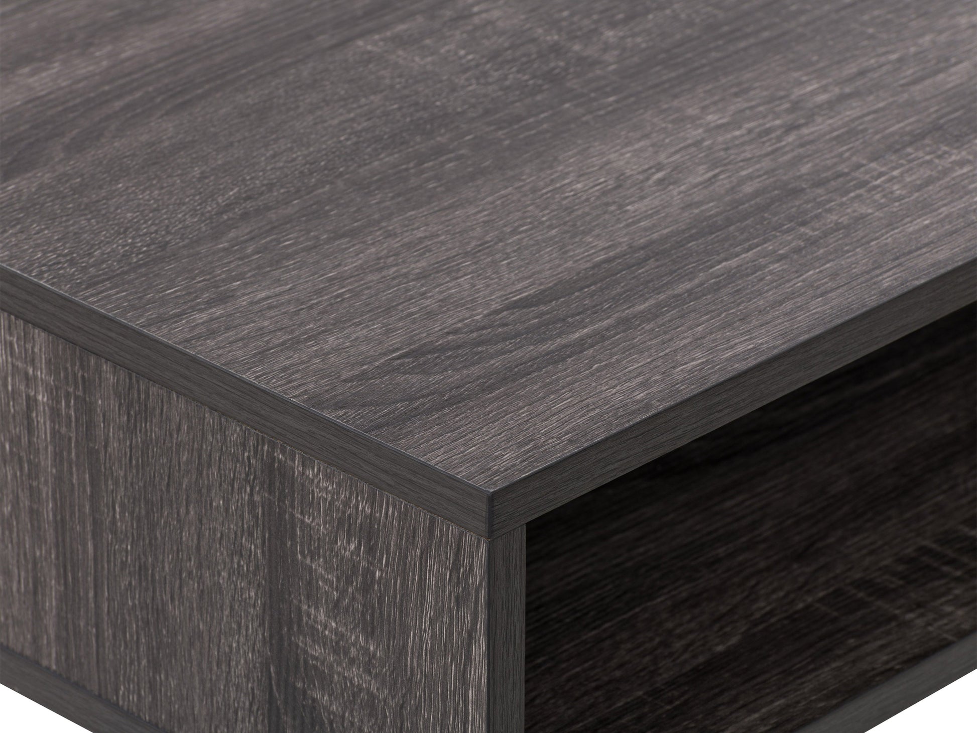 Sleek modern computer desk in grey with a smooth laminate surface, sturdy metal frame, and built-in cable management, ideal for home offices or workspaces.