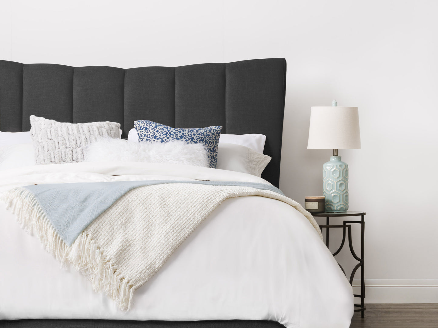 Gray channel-tufted double/full bed with soft velvet upholstery, sleek low-profile design, and sturdy wooden legs. Ideal for modern bedrooms seeking a stylish and comfortable centerpiece.