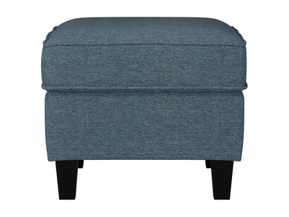 Gray fabric ottoman with tufted top, wooden legs, and mid-century modern design.