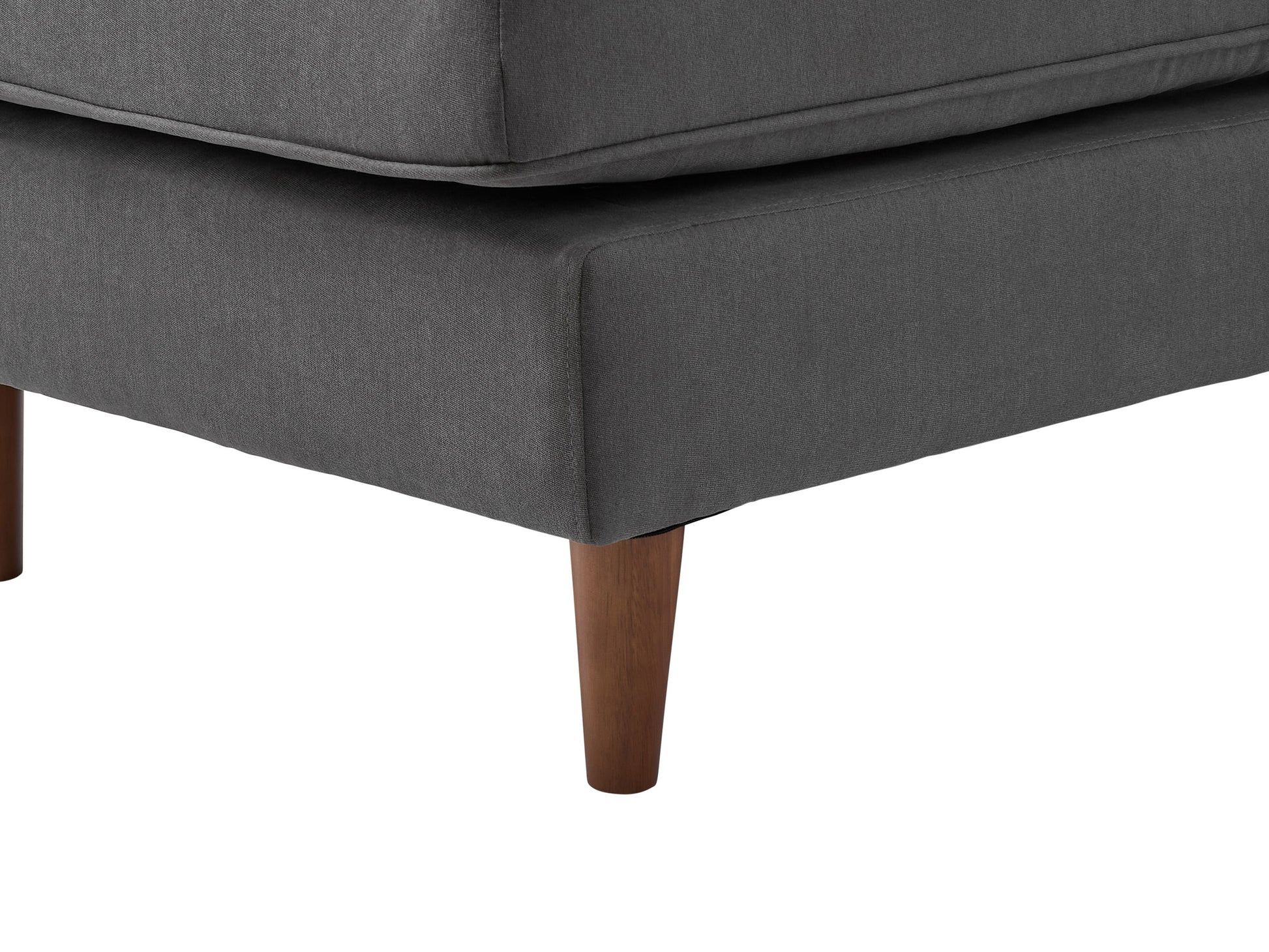 Reversible sectional sofa with light grey upholstery, tufted cushions, and dark wooden legs. Features a chaise lounge on the left side and a modern, minimalist design perfect for contemporary living rooms.