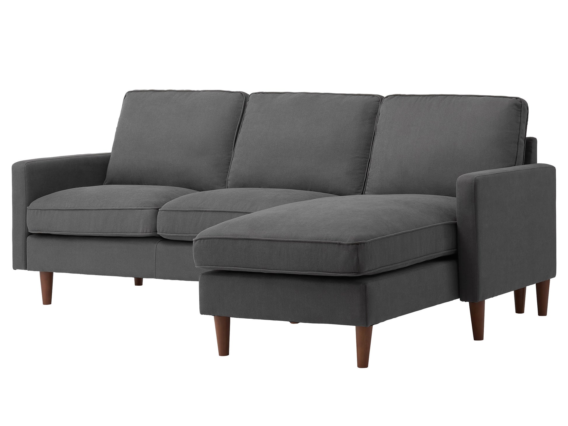 Reversible sectional sofa in light gray fabric with tufted cushions, chaise lounge, and wooden legs. Ideal for modern living rooms, offering comfort and flexibility in seating arrangements.