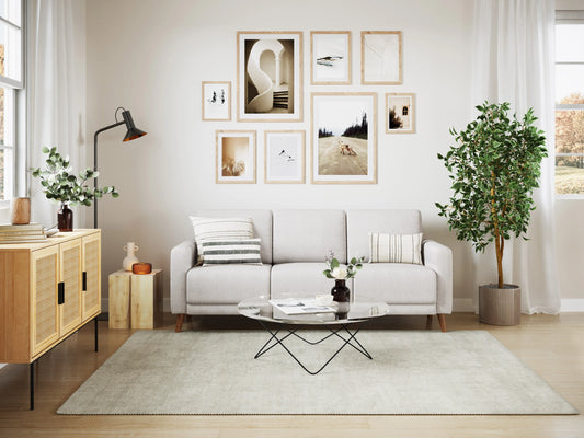 Gray 3-seat sofa with tufted backrest, wooden legs, and soft fabric upholstery, perfect for modern living rooms.
