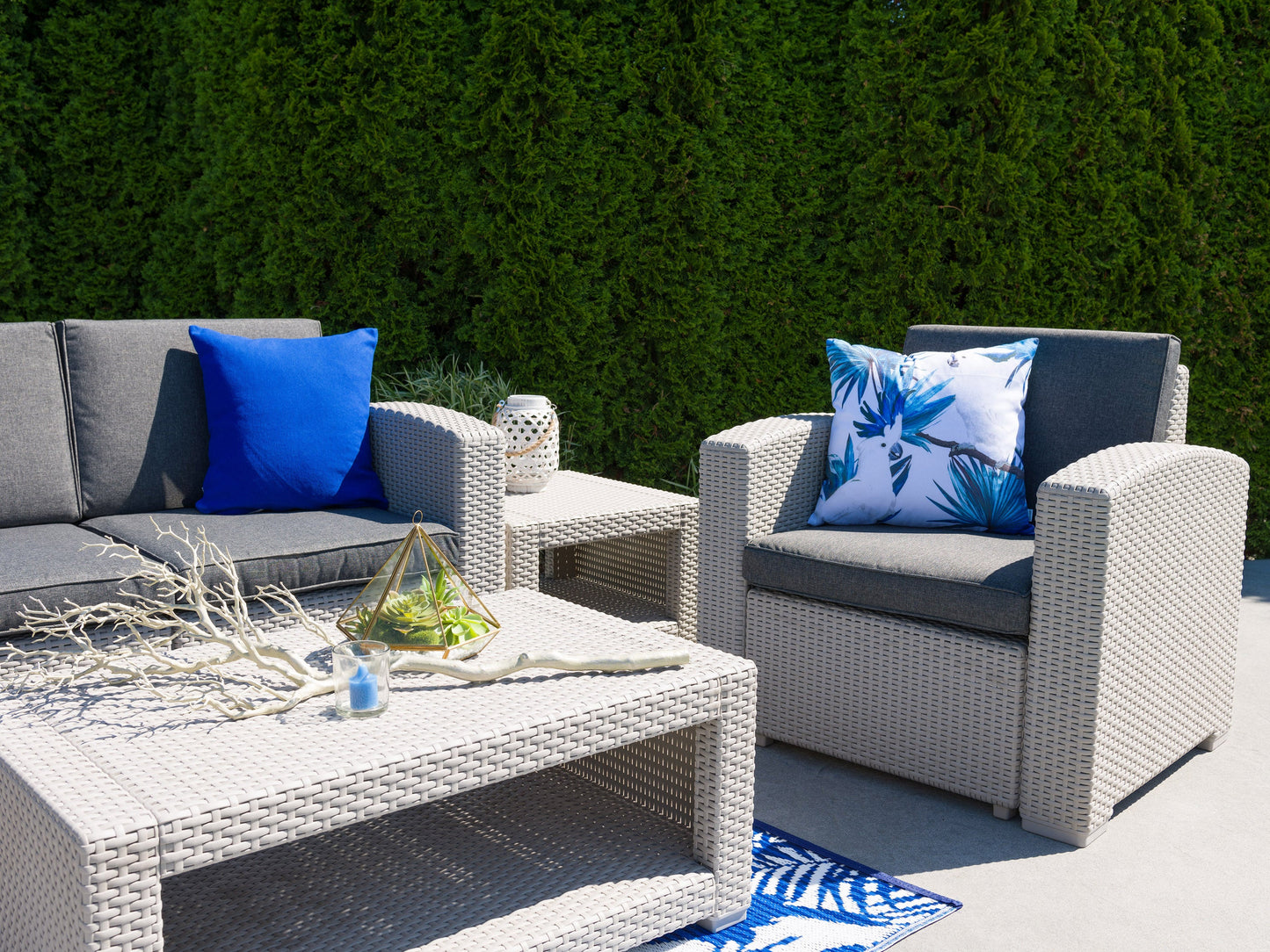 6 piece patio conversation set with beige cushions, black metal frames, and glass-top coffee table, featuring two armchairs, two ottomans, and a loveseat, ideal for outdoor lounging and entertaining.