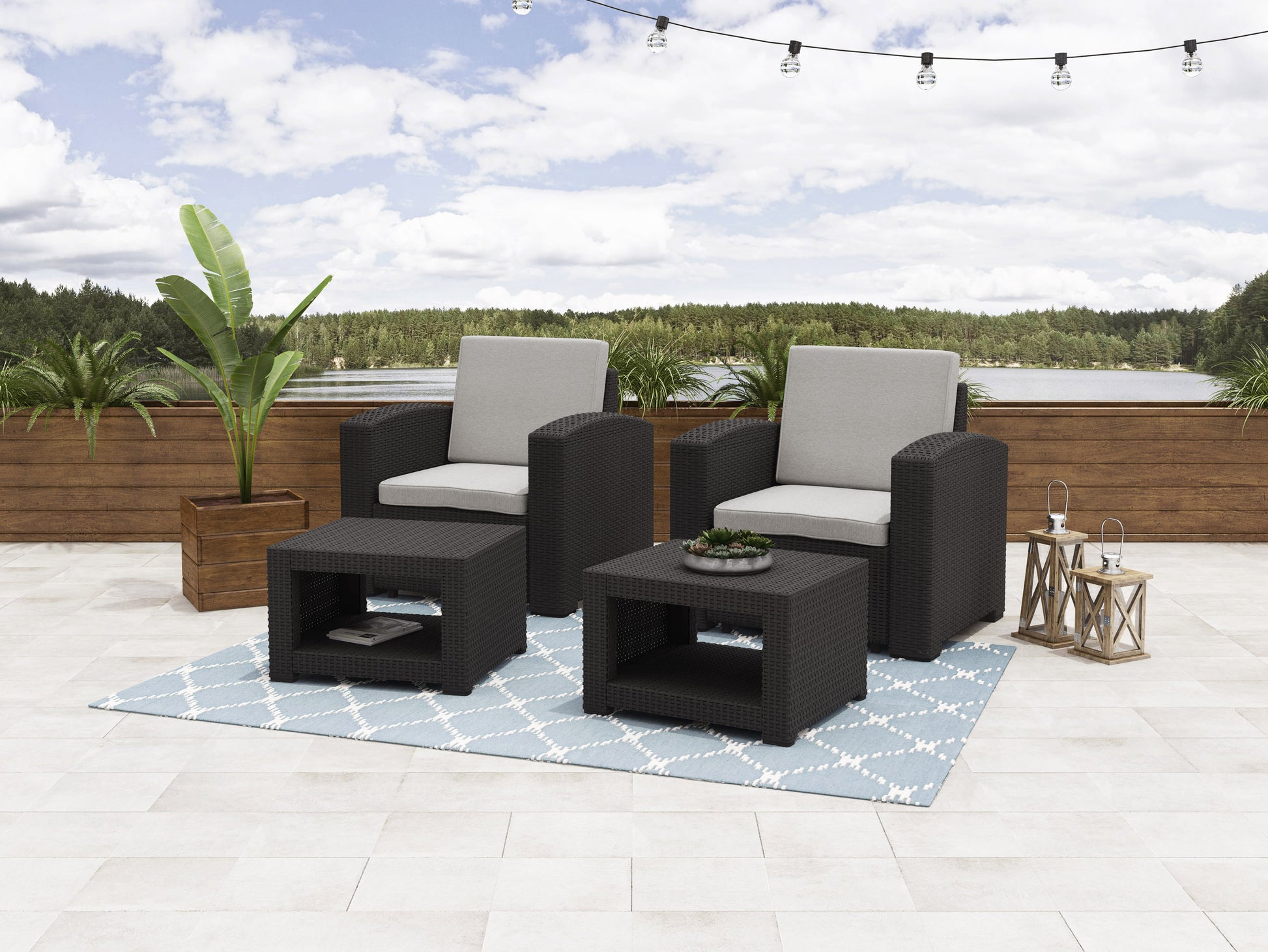 Outdoor patio conversation set with two gray cushioned chairs, matching ottomans, and a glass-top side table, featuring a sleek black metal frame and woven rattan accents, perfect for modern outdoor spaces.