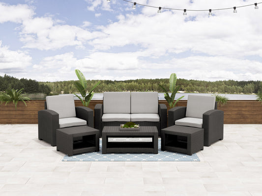 6 piece patio conversation set with gray wicker, beige cushions, glass-top coffee table, and textured throw pillows, perfect for outdoor lounging and entertaining.