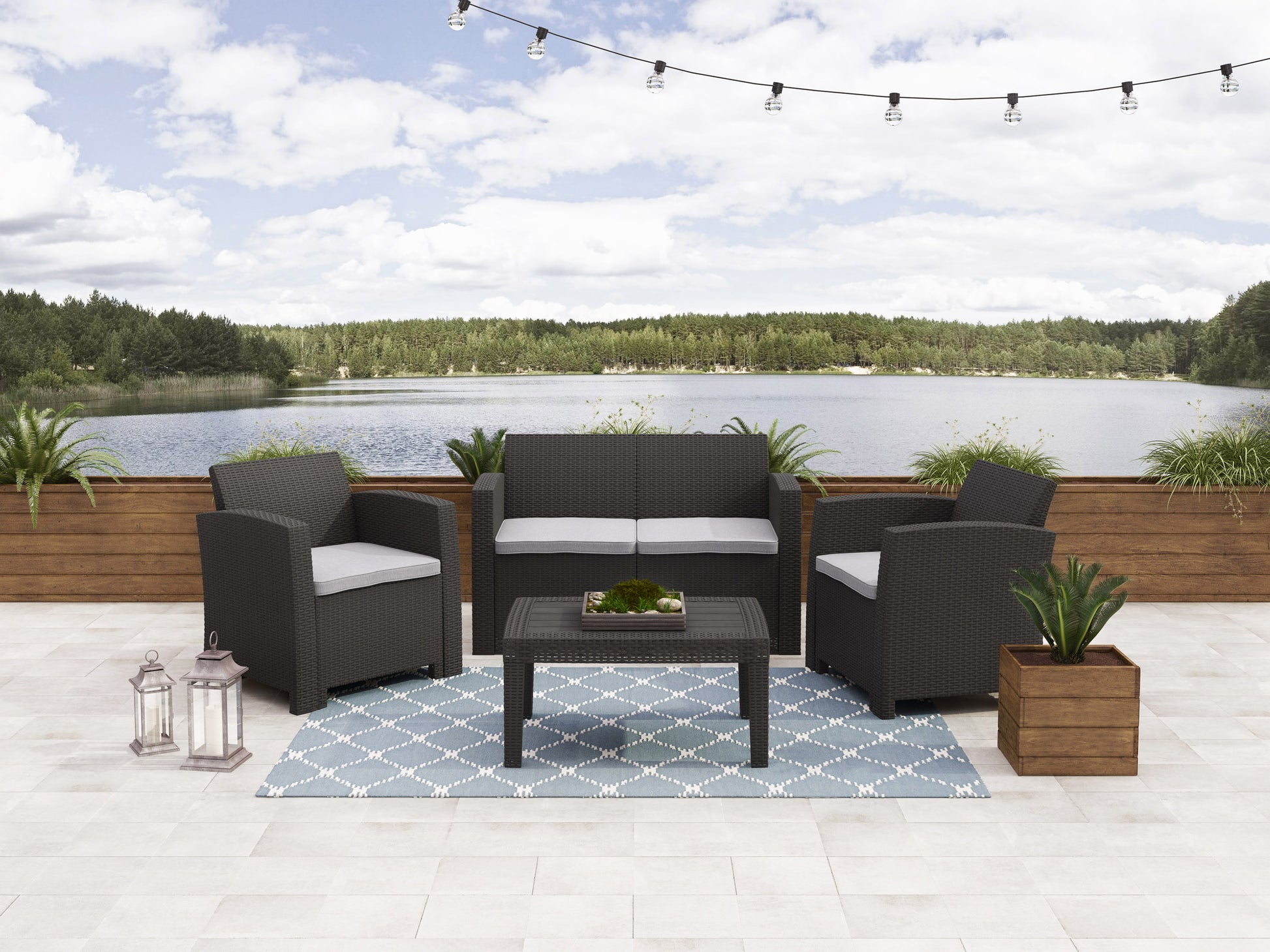 Modern outdoor conversation set with a beige cushioned sofa, two armchairs, and a glass-top coffee table, all with sleek black metal frames. Ideal for patio lounging and garden entertaining.