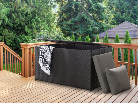 Gray wicker patio storage box with a flat lid, featuring a weather-resistant design and ample storage space, ideal for outdoor cushions and gardening tools.