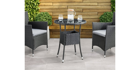 Modern black metal patio bistro table with round top and sleek, minimalist design, set on a wooden deck with greenery in the background. Ideal for outdoor dining and garden decor.