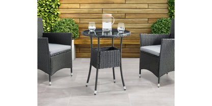 Modern black metal patio bistro table with round top and sleek, minimalist design, set on a wooden deck with greenery in the background. Ideal for outdoor dining and garden decor.