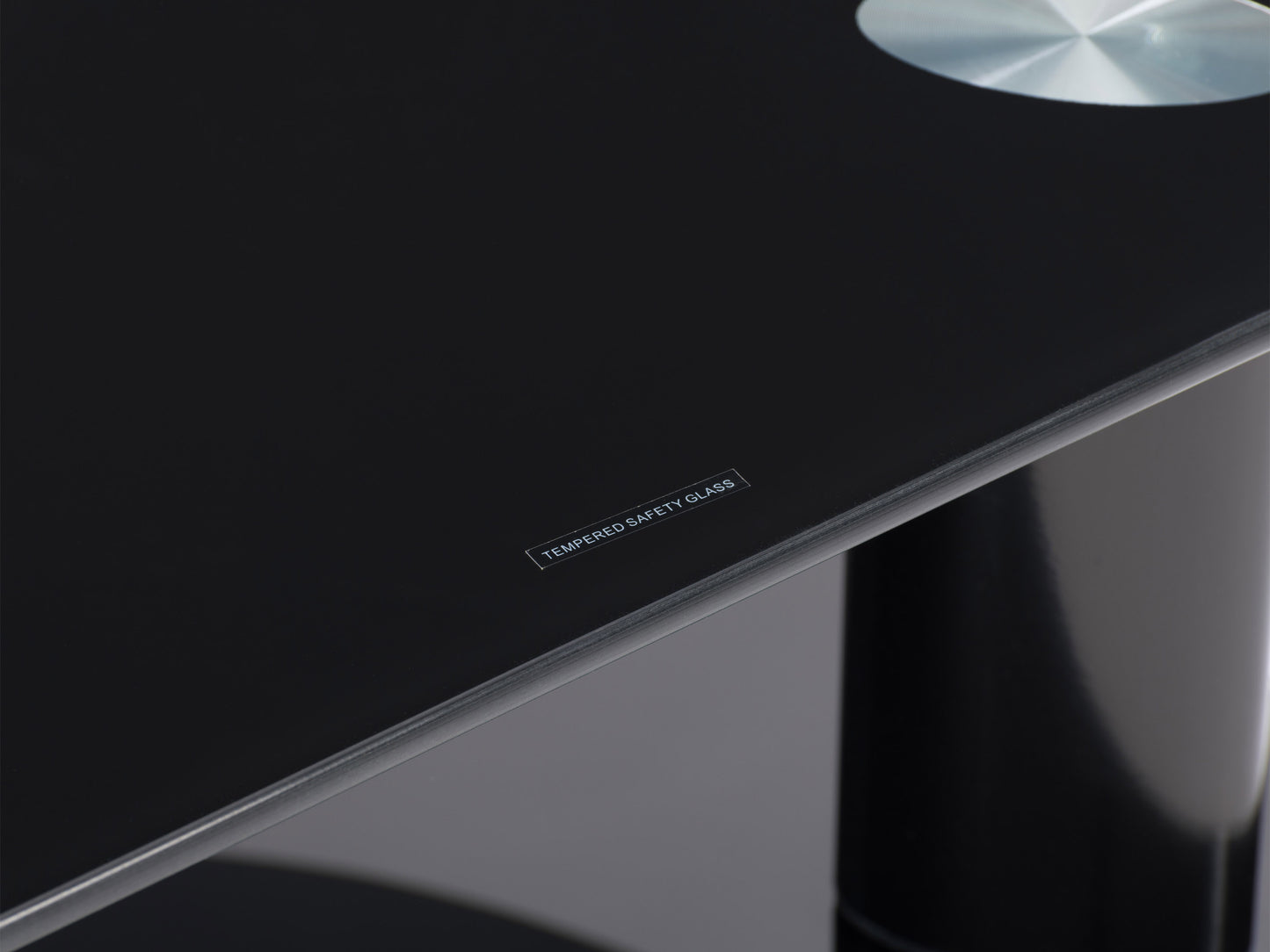 Black glass TV stand with chrome legs, three-tiered shelving, and cable management system, designed for TVs up to 48 inches.