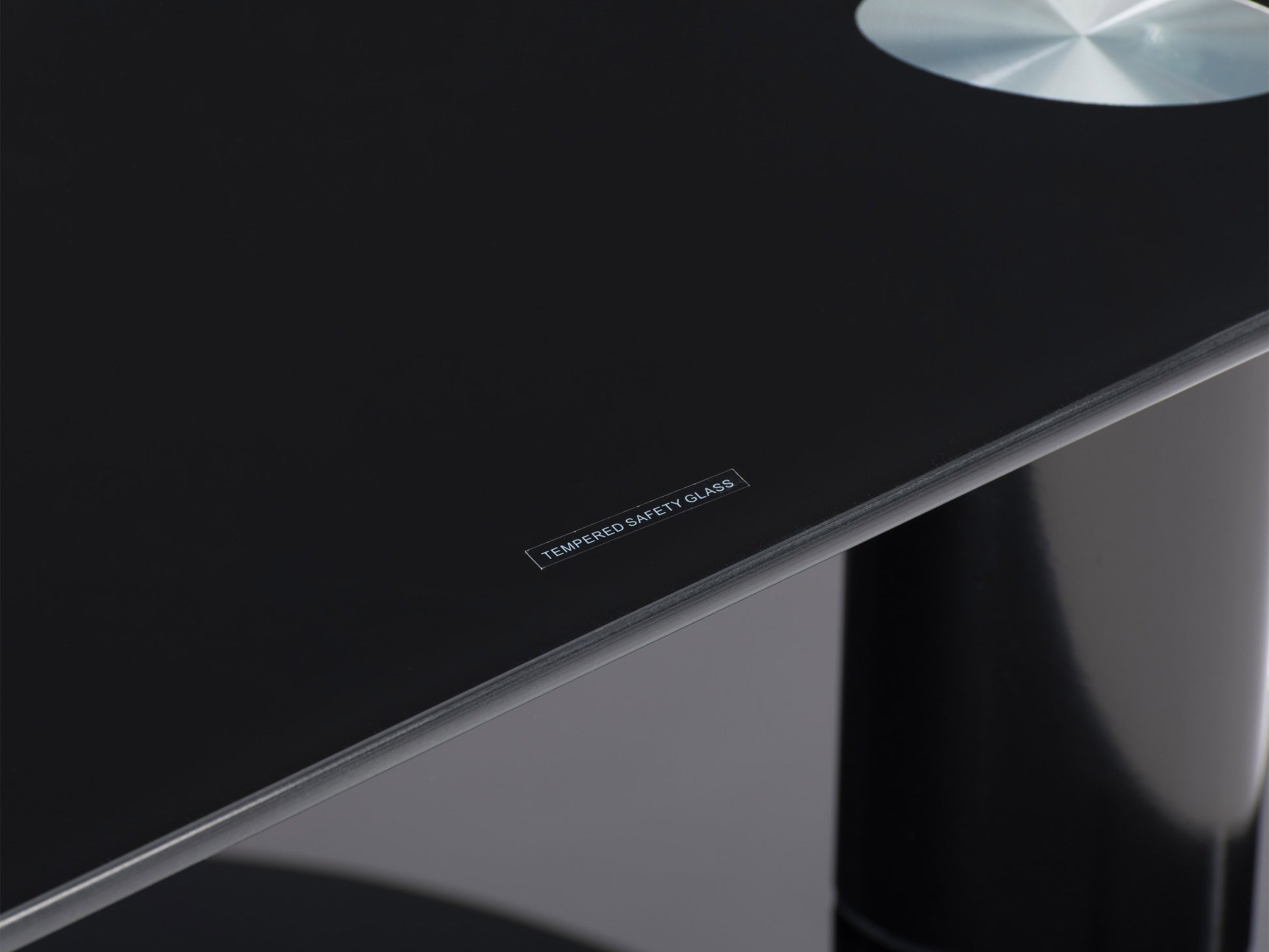 Black glass TV stand with chrome legs, three-tiered shelving, and cable management system, designed for TVs up to 48 inches.