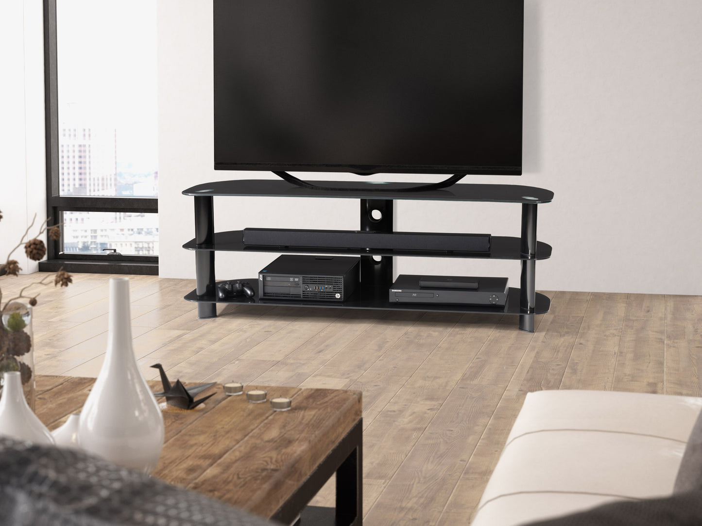 Black glass TV stand with sleek metal frame, three tempered glass shelves, and cable management system, suitable for TVs up to 65 inches. Ideal for modern living rooms or entertainment spaces.