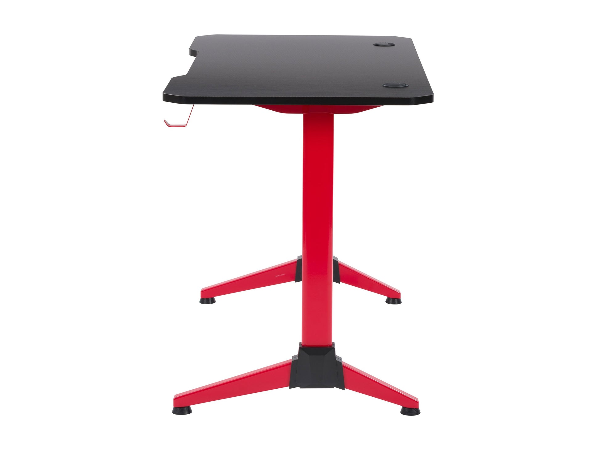 Red and black gaming desk with sleek carbon fiber texture, built-in cup holder, headphone hook, and cable management grommets, designed for gamers seeking a stylish and functional workspace.